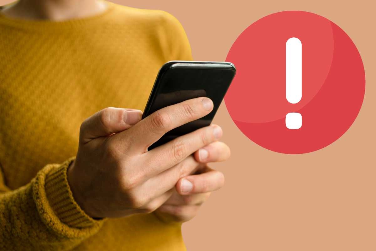 Persona con cellulare, simbolo attenzione